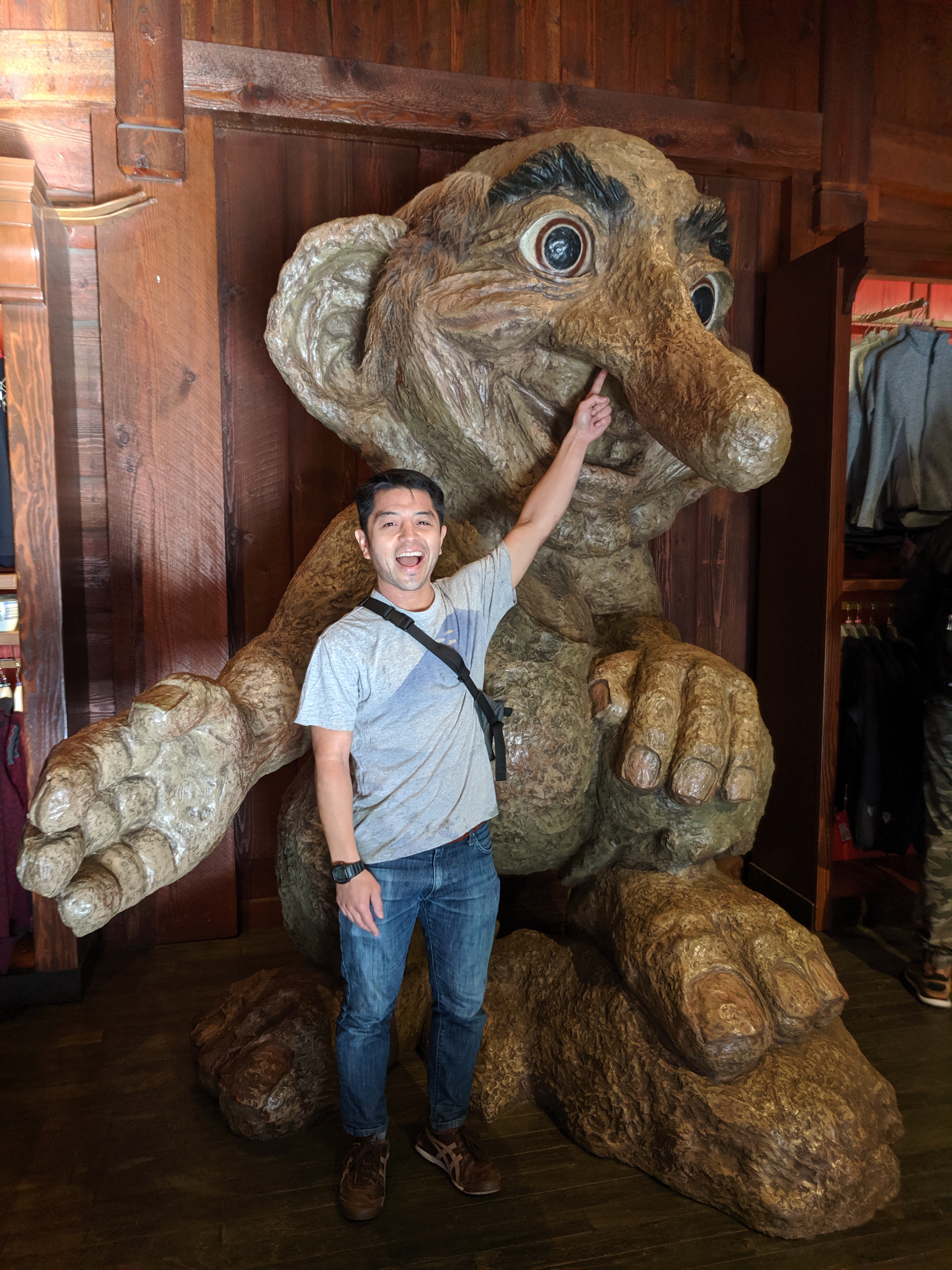 Me playfully picking nose of troll statue at Disney World